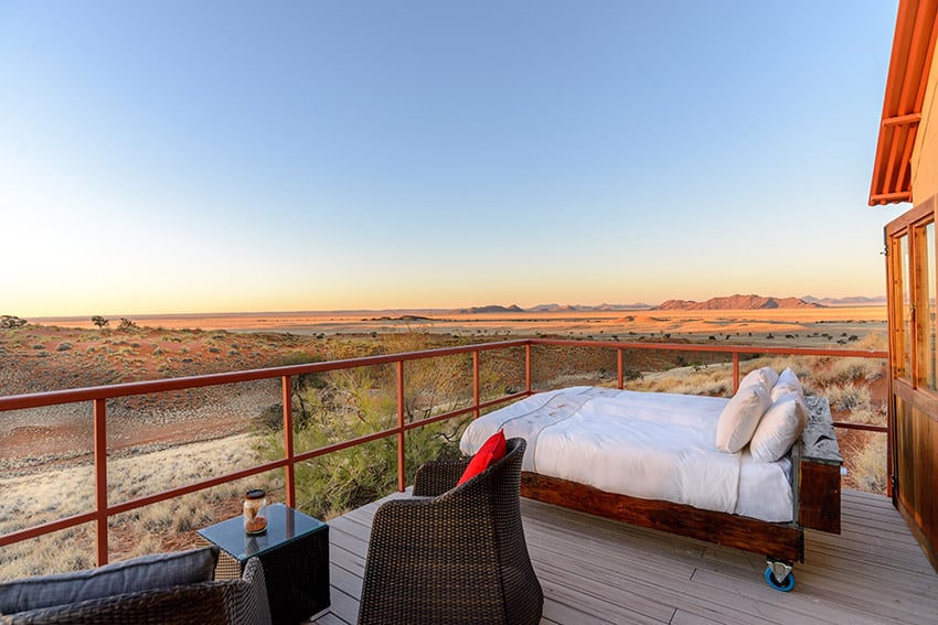 Lodge bed on balcony, Namib desert view, Namibia
