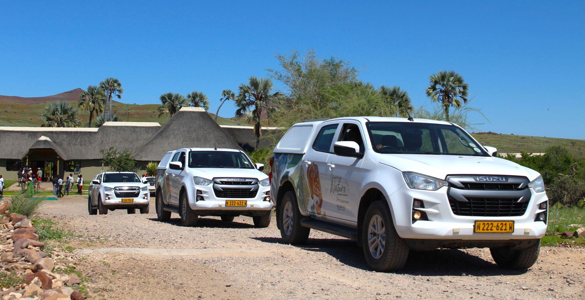 Three white vehicles that were donated to the conservancies. 