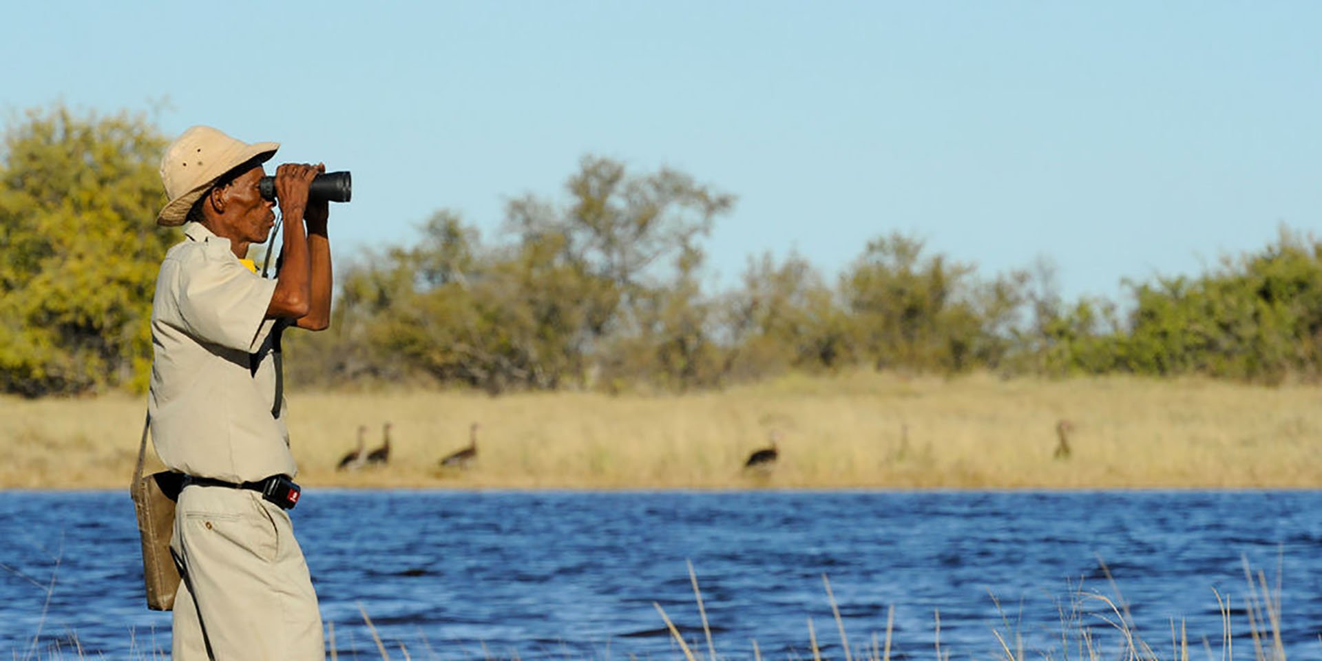 Man with binoculars, Zambezi Region