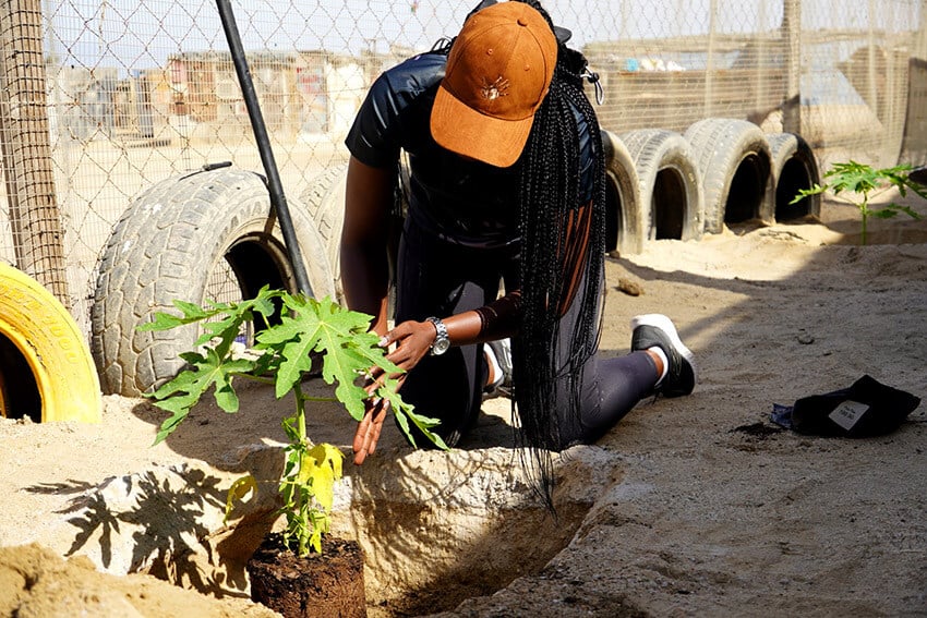 Namibian women, kneeling, gardening
