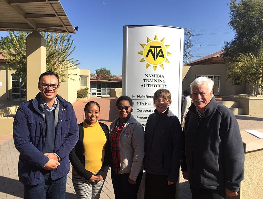 Namibians standing in front of signage